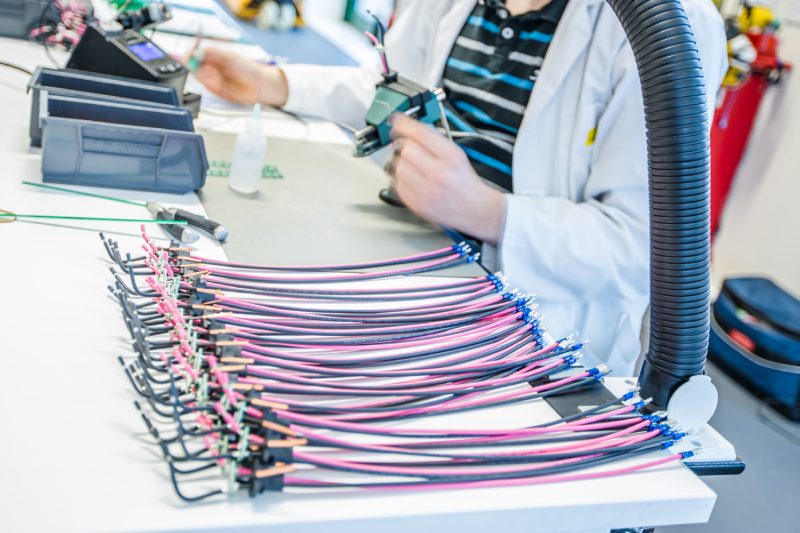 Batch of finished cable assemblies on the production bench